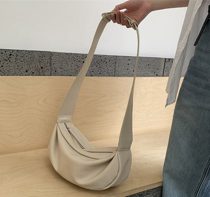 Soft side profile crossbody bag with flat back panel for hip comfort