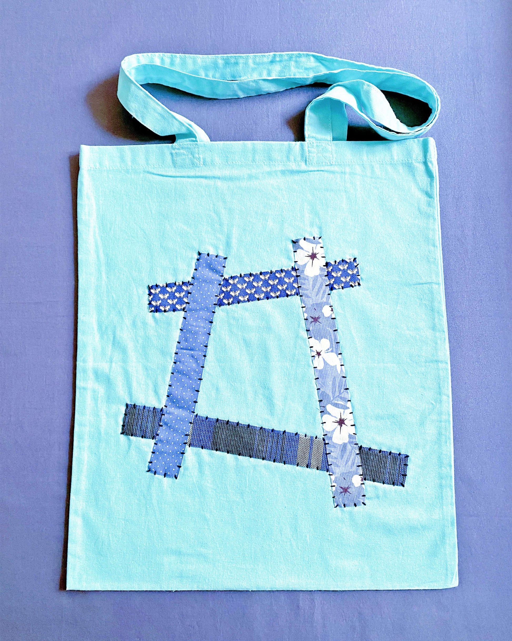 Ultra-soft blue cotton tote that feels like a warm hug, perfect for carrying books to a quiet coffee shop afternoon.