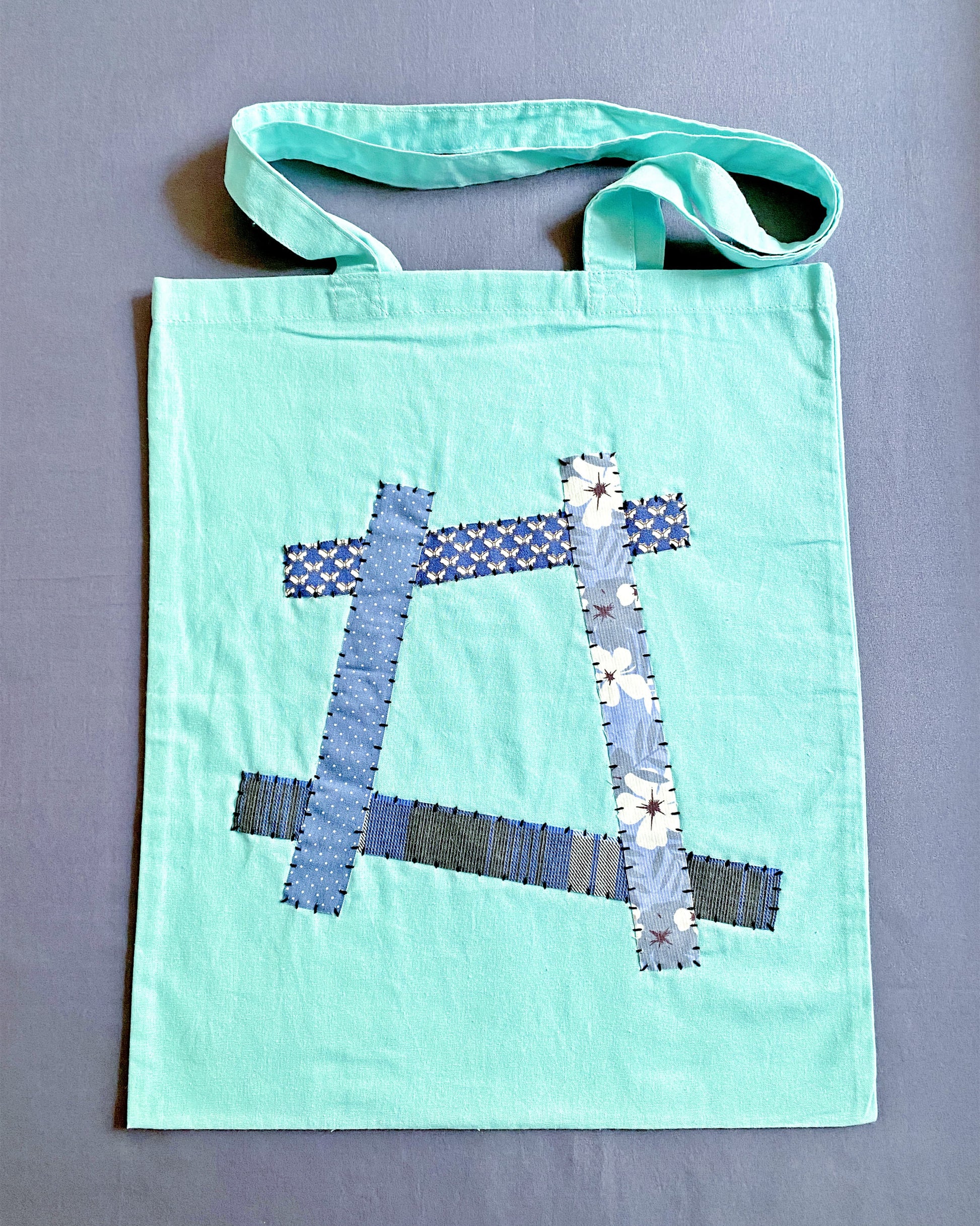 light blue fabric bag used for grocery runs and daily errands