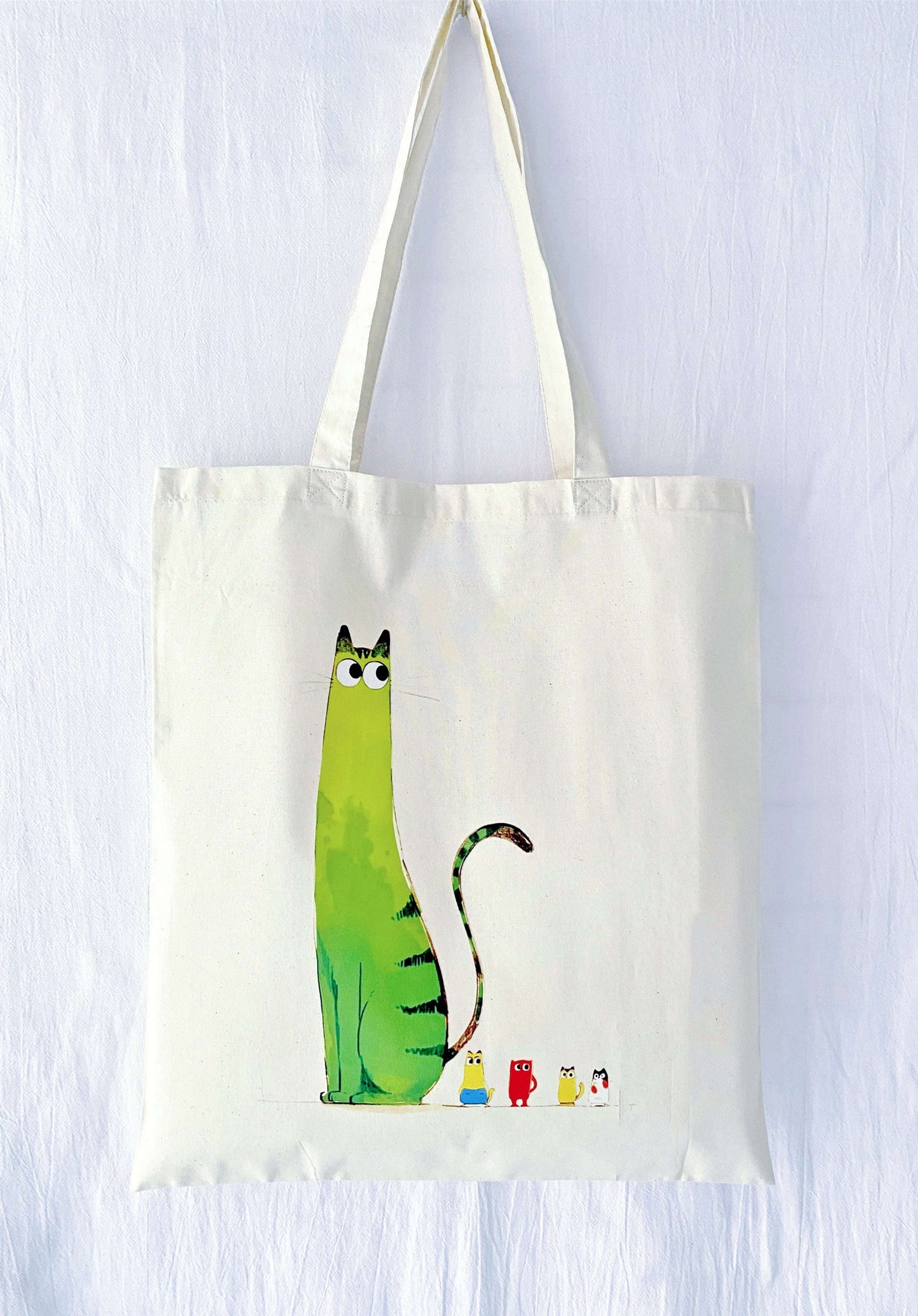 A large, ultra-soft cotton tote featuring a hand-printed cat, appreciated by those who want comfort and space without stiffness.