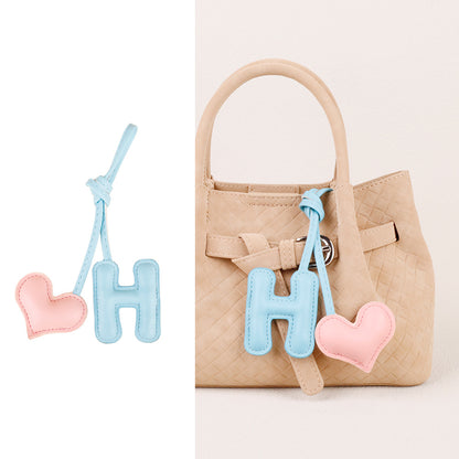 Letter heart decoration paired with a leather bag