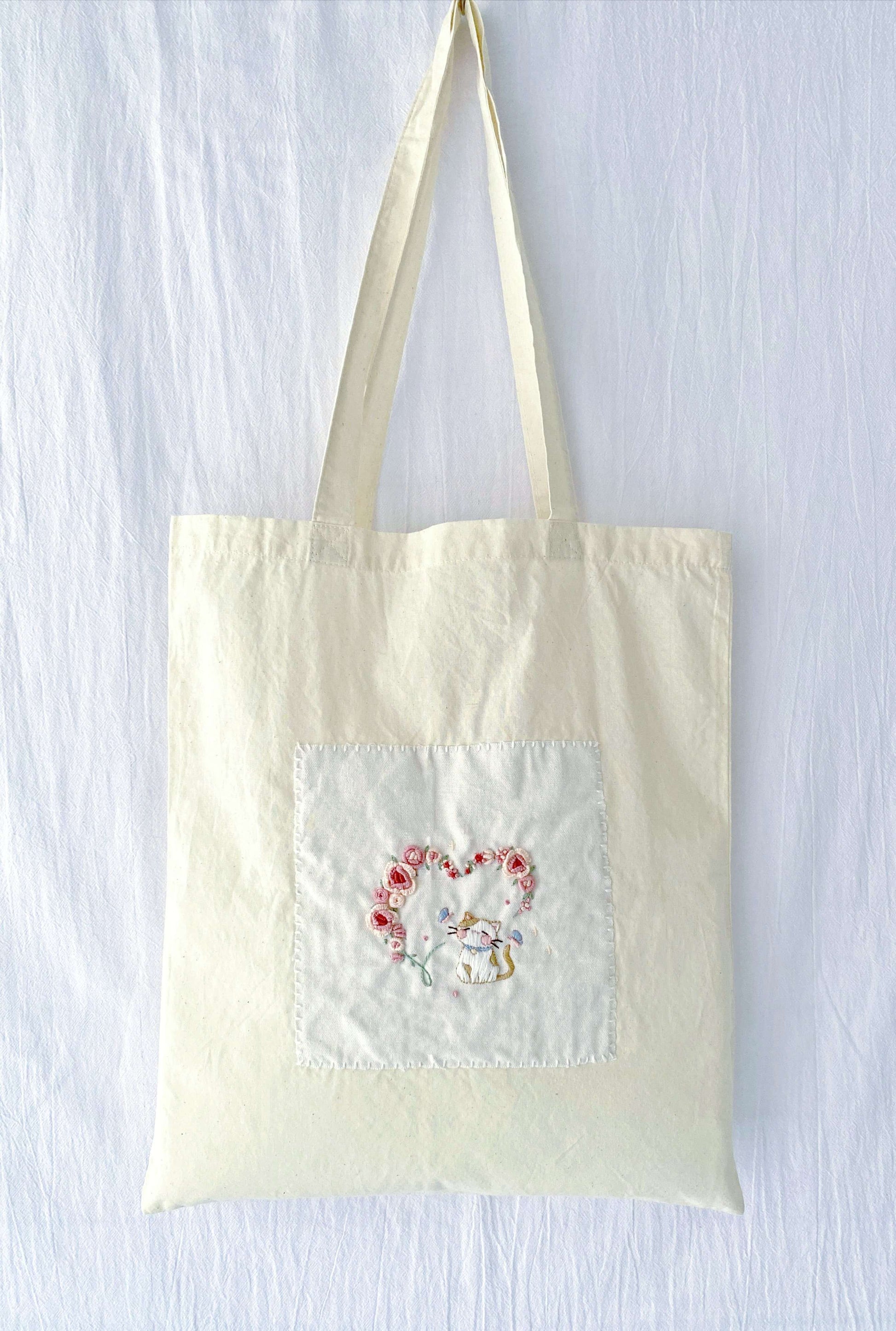 Zero-waste natural cotton shopper with hand-embroidered roses, perfect for plastic-free market days.
