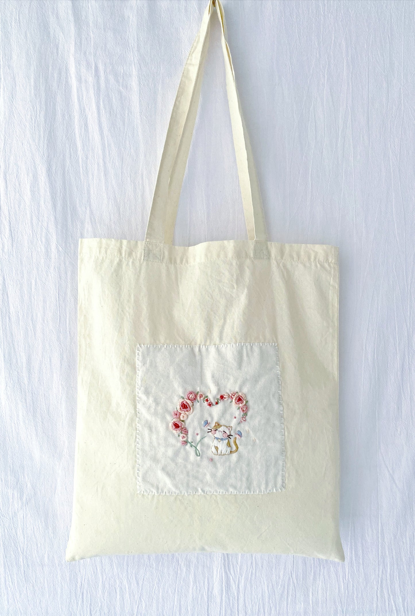 Close-up of the charming, relaxed-vibe cat pattern pre-printed for DIY hand embroidery.