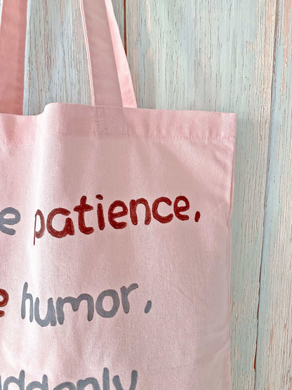 Pink tote with hand-lettered text for a unique, personalized look.