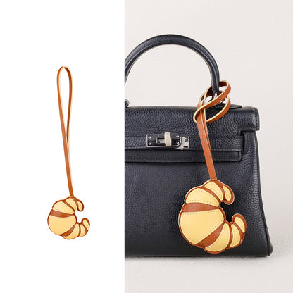 Purse accessory gift with a playful croissant-inspired shape