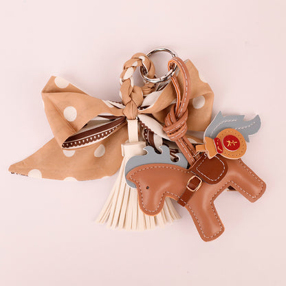 French-inspired bow hanger with a long tassel