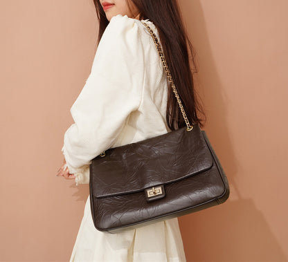 Fashion-forward Women's Soft Leather Crossbody Bag with Chain Detail