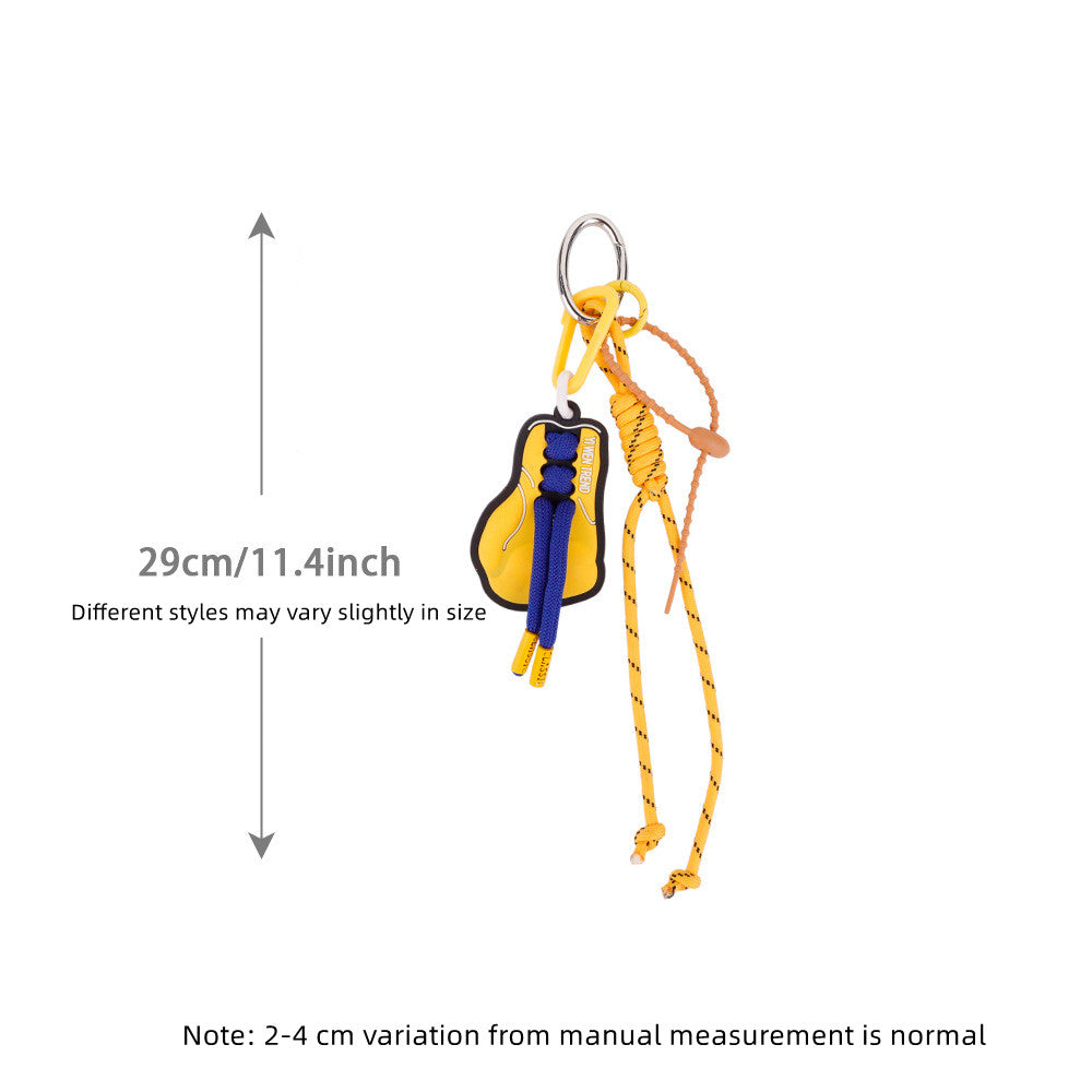 Charming yellow handmade keychain charm dangling from a stylish commuter bag