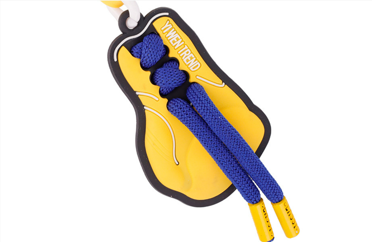 Yellow athletic aesthetic bag charm pinned to an outdoor travel backpack