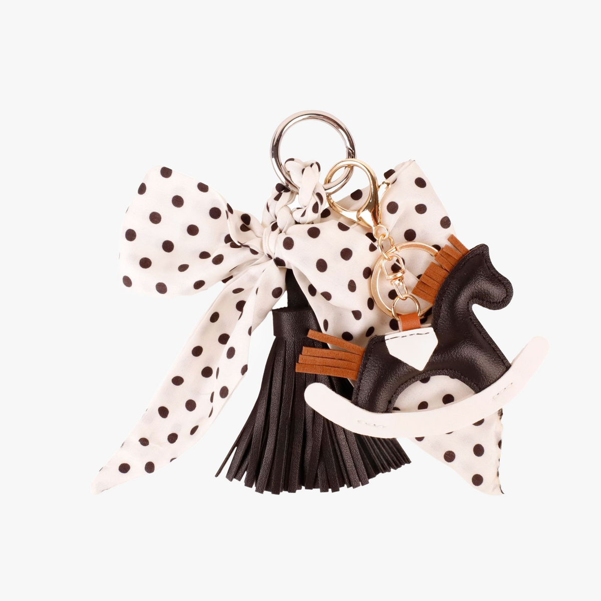 French polka dot silk ribbon tied around a dark leather handbag strap