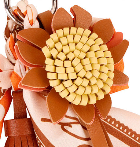 Orange scarf bow accessory with a soft tassel finish