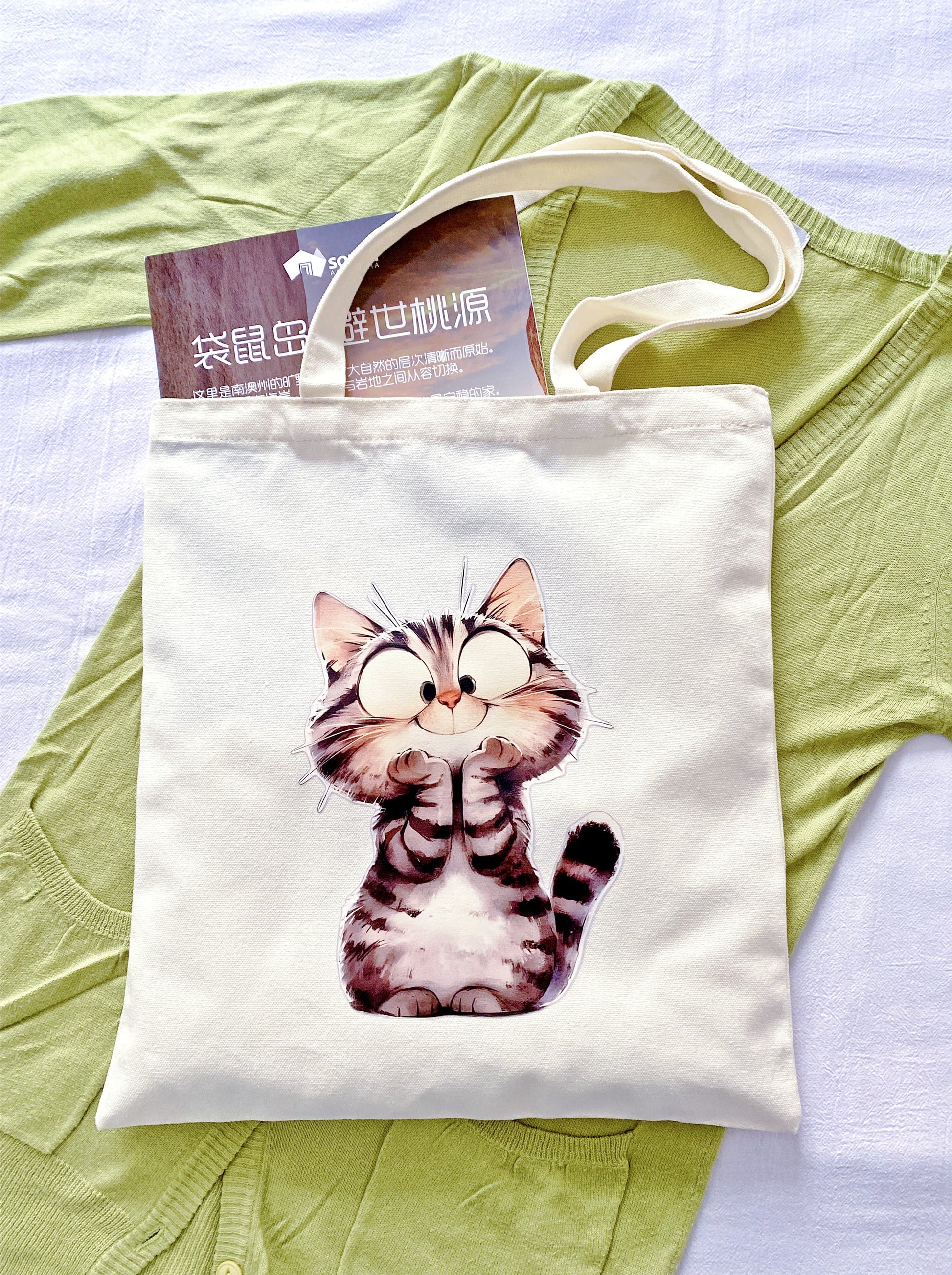 Reusable earth-friendly shopping bag showcasing an original hand-printed kitten design for conscious consumers.