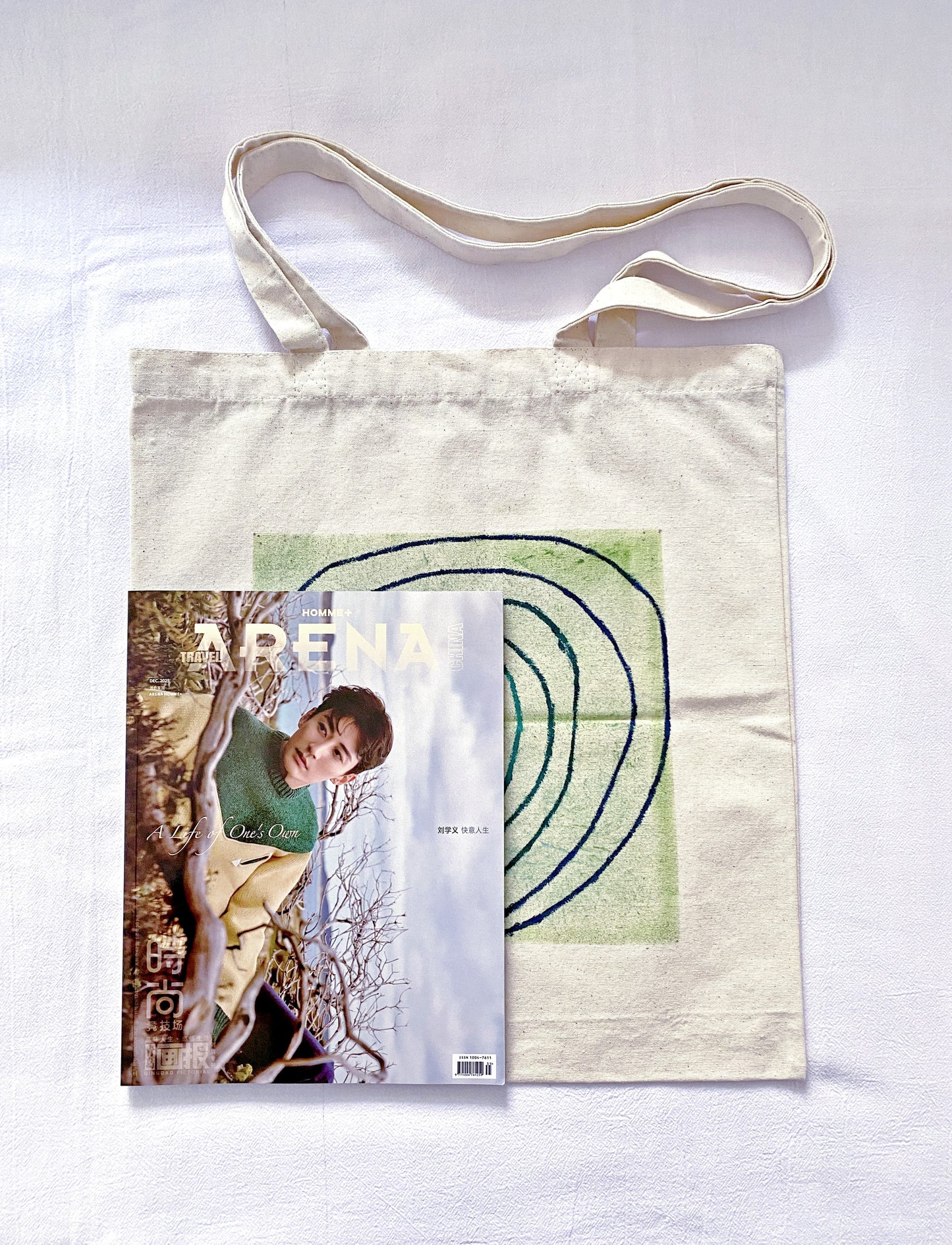 Someone reaching into a large unbleached canvas bag to pull out a film camera.