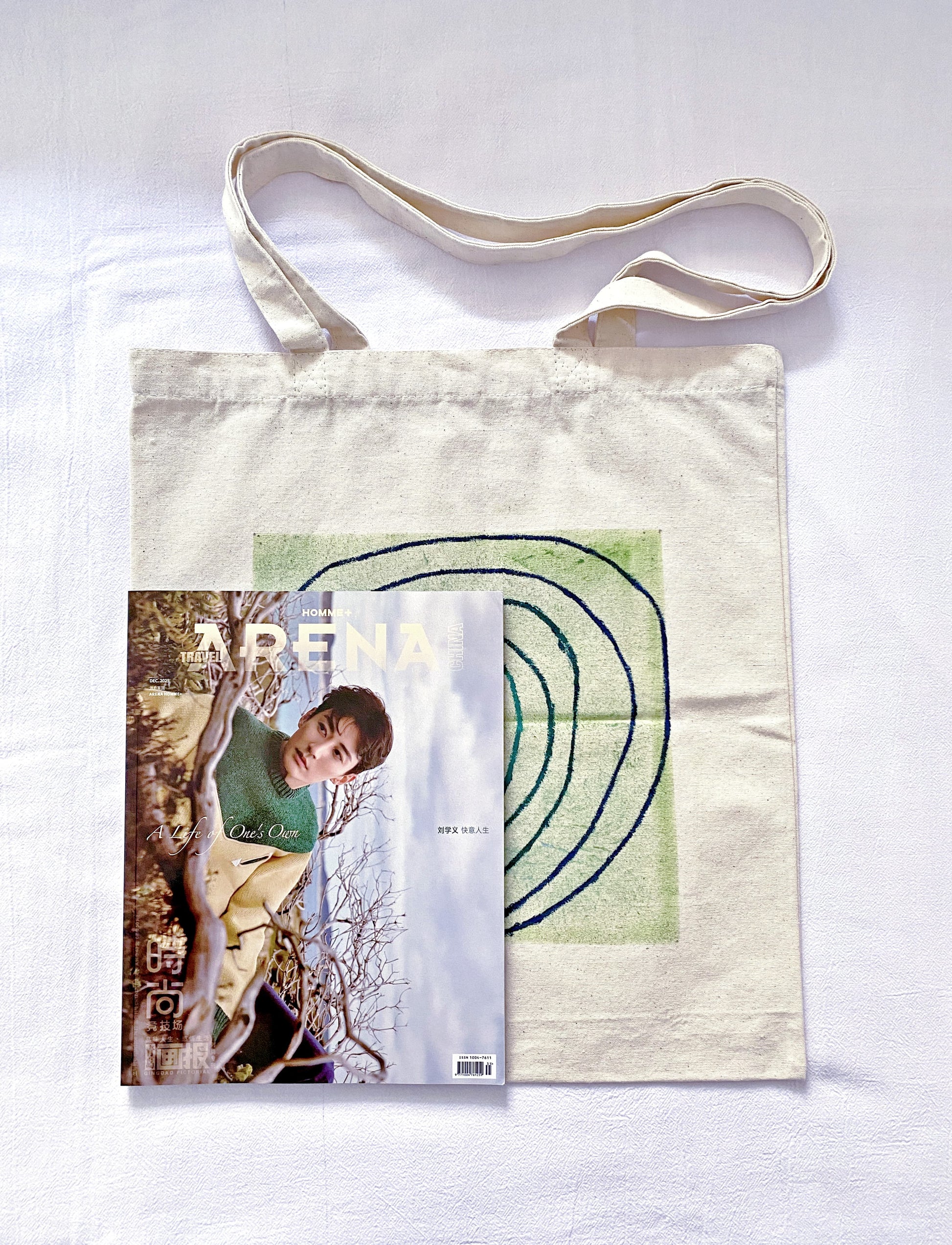 Someone reaching into a large unbleached canvas bag to pull out a film camera.