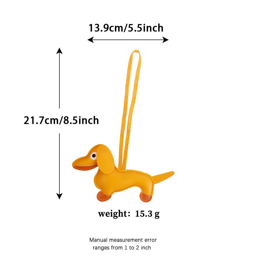 Premium leather sausage dog bag charm styled on a textured handbag