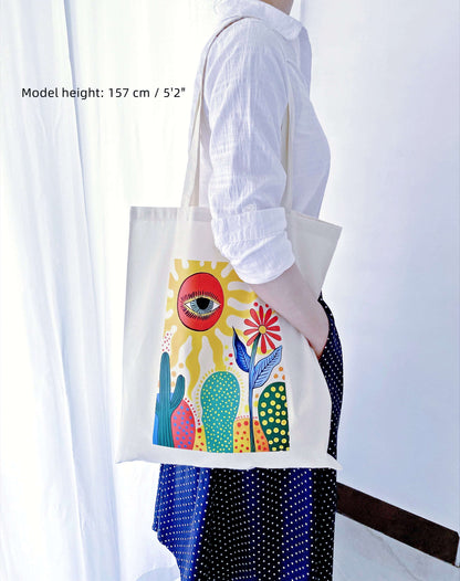 The hand-printed sun cactus bag folded neatly inside a gift box, showing a lightweight present idea that is easy to mail to long-distance family.