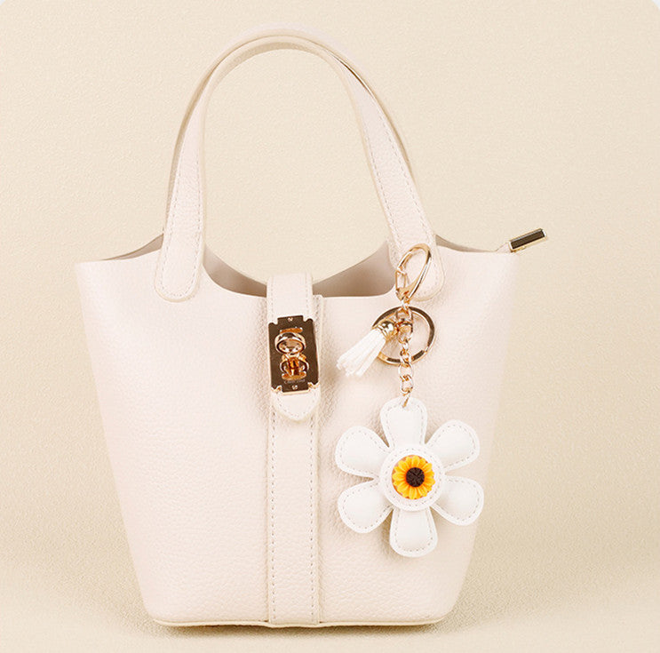 Small sunflower accessory hanging from a fabric bag