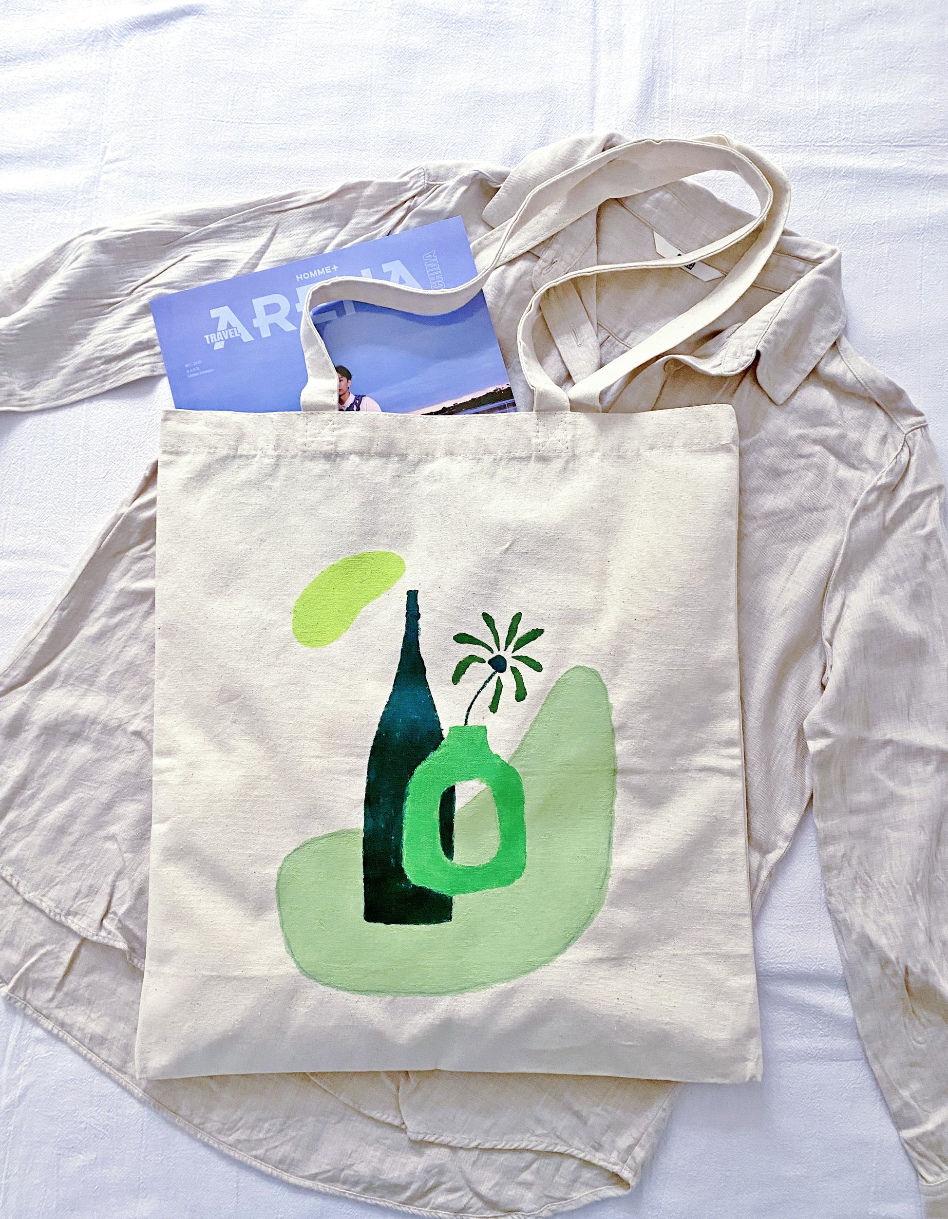 A spacious cream-colored tote bag styled with a minimalist linen outfit for a quiet luxury aesthetic.