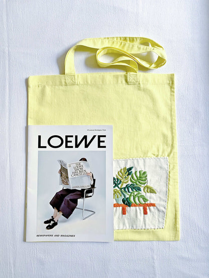Yellow cotton tote with soft texture and botanical embroidery, a casual gift for holidays or special occasions
