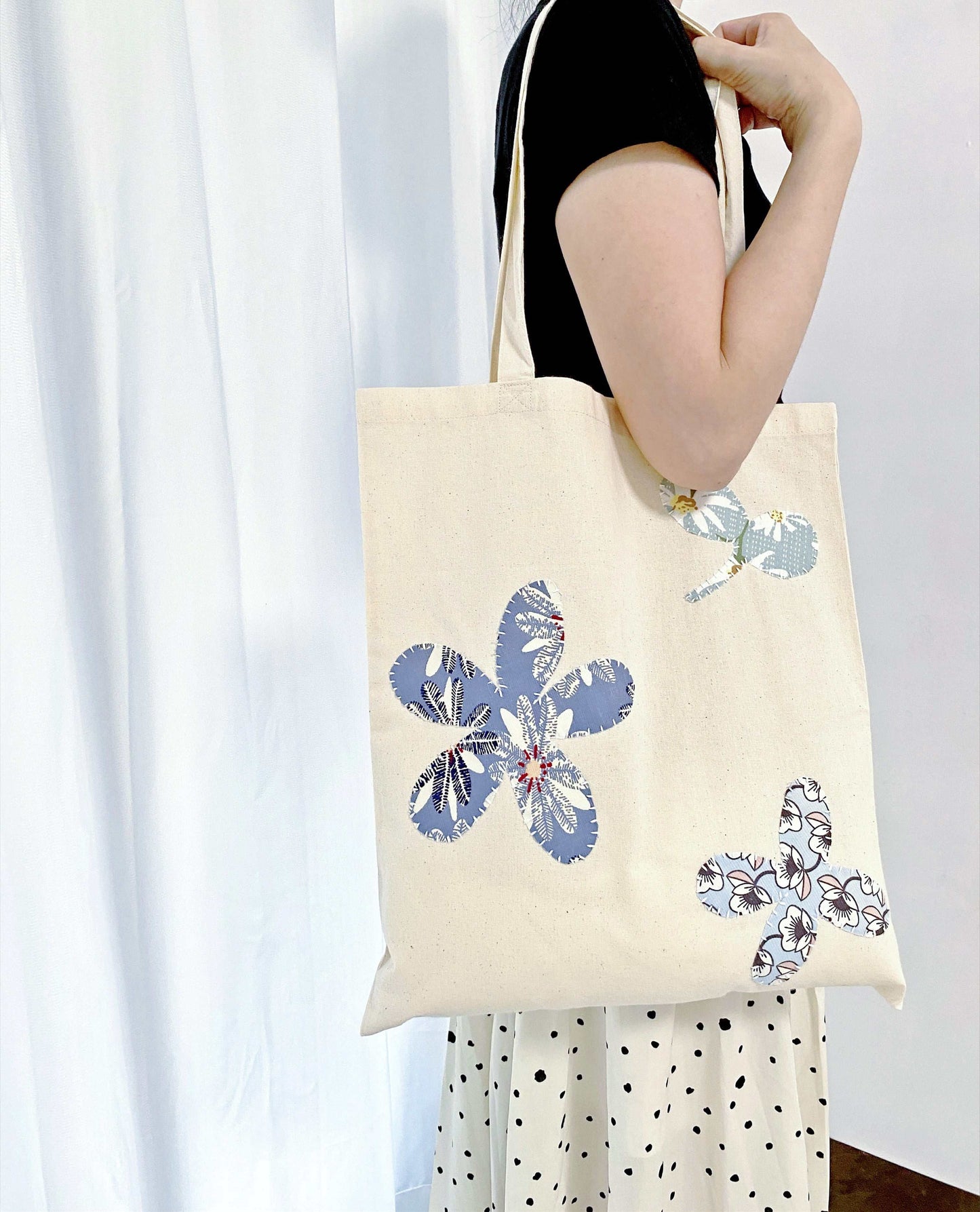 Sustainable cotton tote bag styled with a relaxed, minimalist summer outfit.
