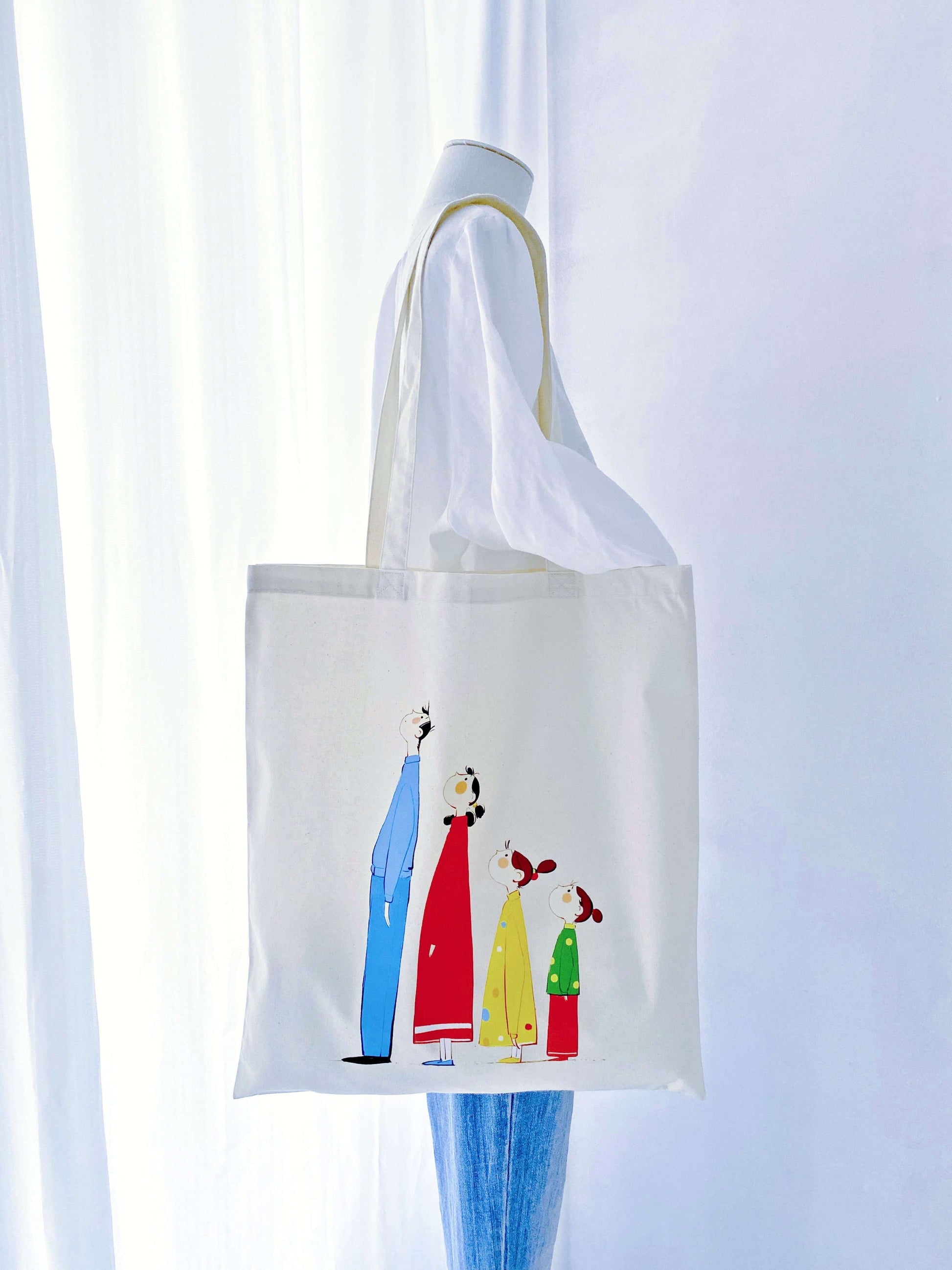 Large capacity, soft cotton tote with a unique hand-printed family motif—an accessory that adds a personal touch to everyday style.