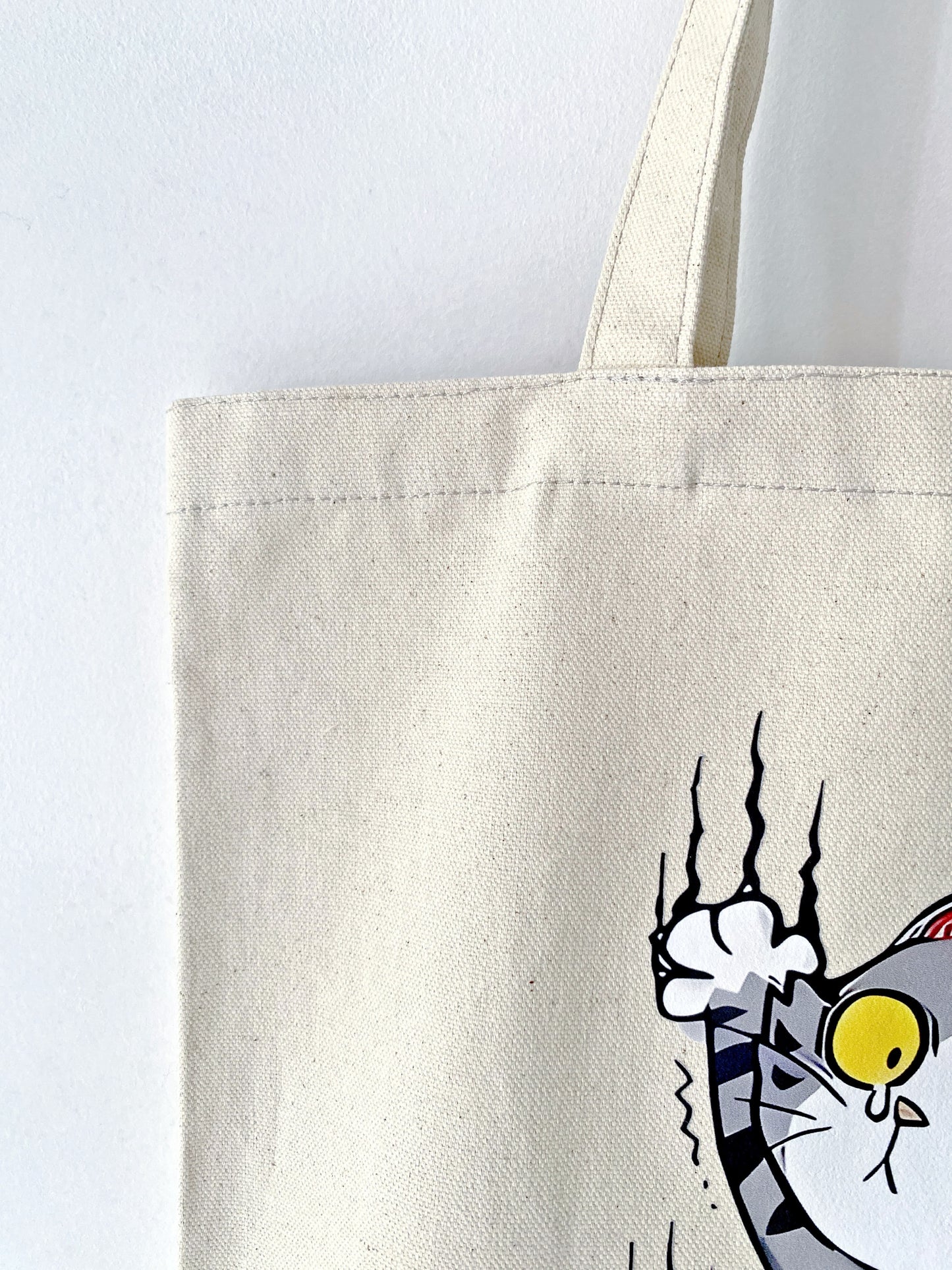 Breathable cotton canvas tote holding a yoga mat and water bottle