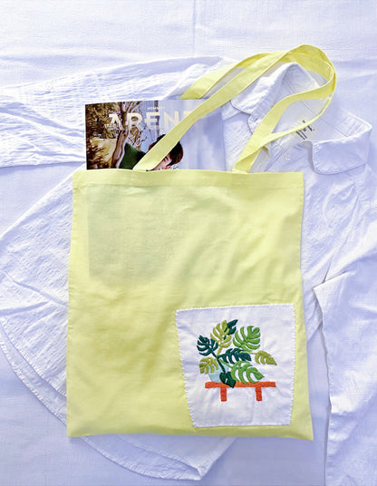 Lightweight eco-friendly shoulder bag packed with farmers market finds.