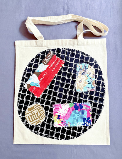 Durable natural canvas tote bag styled with a unique artisanal patchwork design.