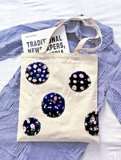 Eco-friendly canvas tote with handcrafted patchwork details for a mindful morning commute.
