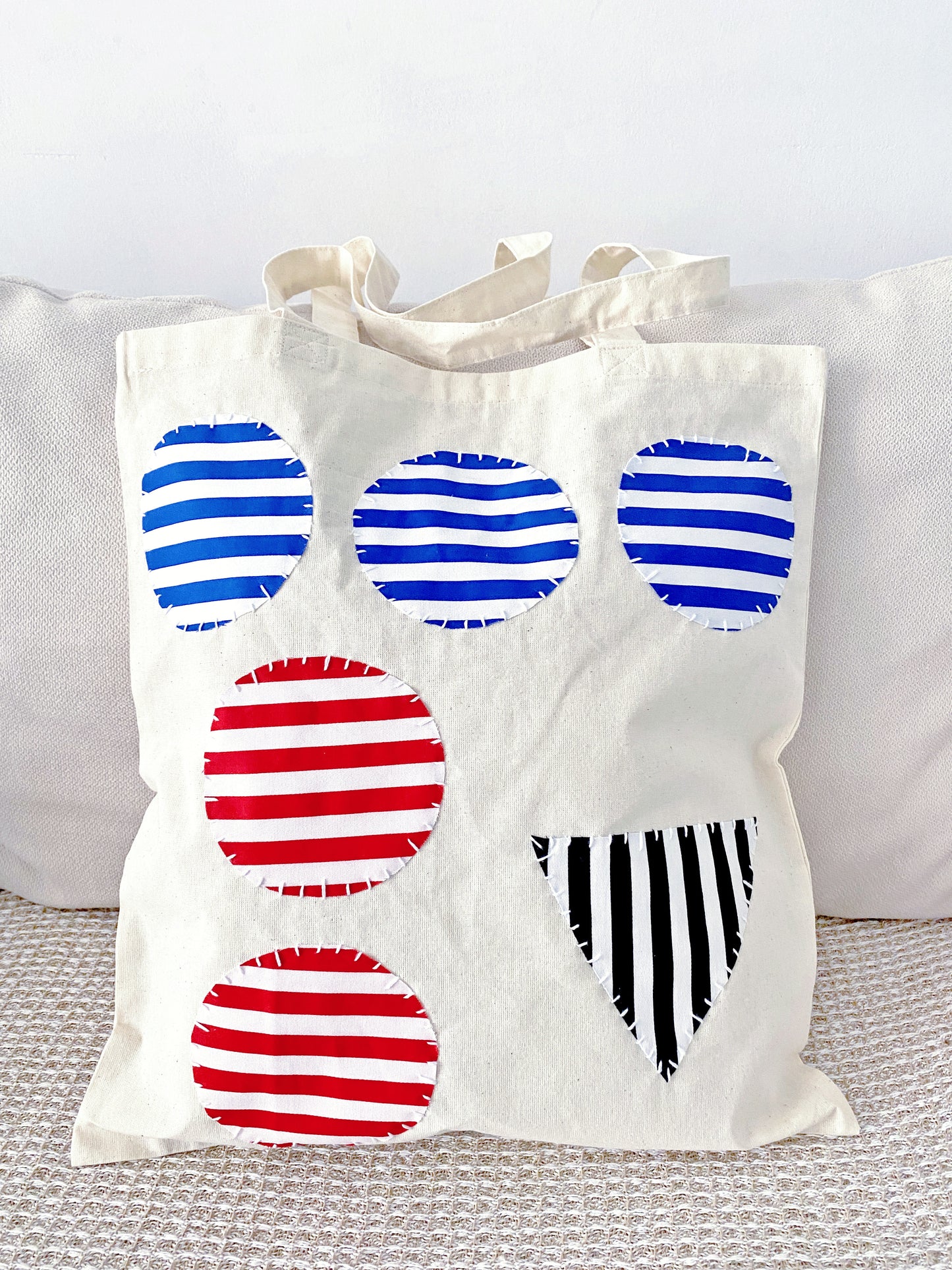 A soft cotton tote with hand-stitched patchwork, often appreciated by users who prefer texture and warmth over polished design.