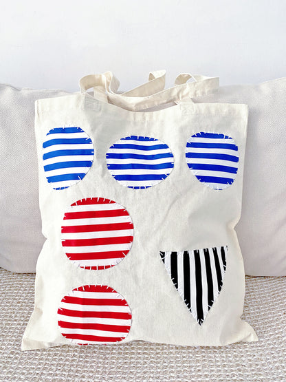 A soft cotton tote with hand-stitched patchwork, often appreciated by users who prefer texture and warmth over polished design.