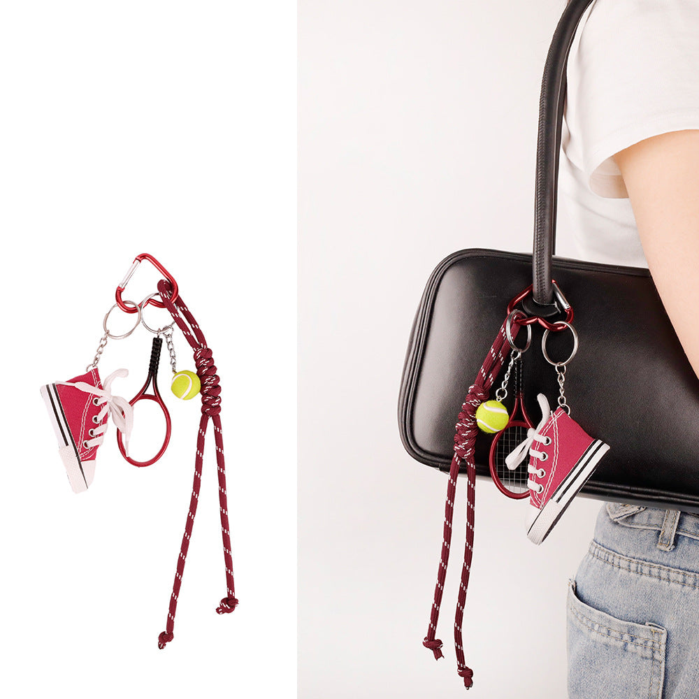 Tassel bag accessory clipped beside a backpack zipper