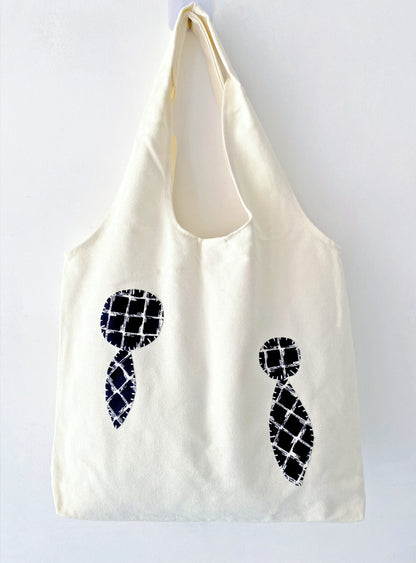 Eco-friendly canvas tote with cheerful stitched patches