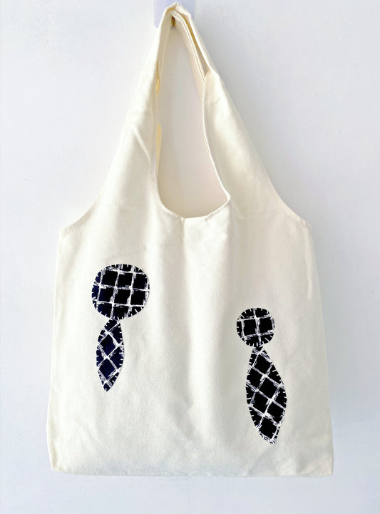 Eco-friendly canvas tote with cheerful stitched patches