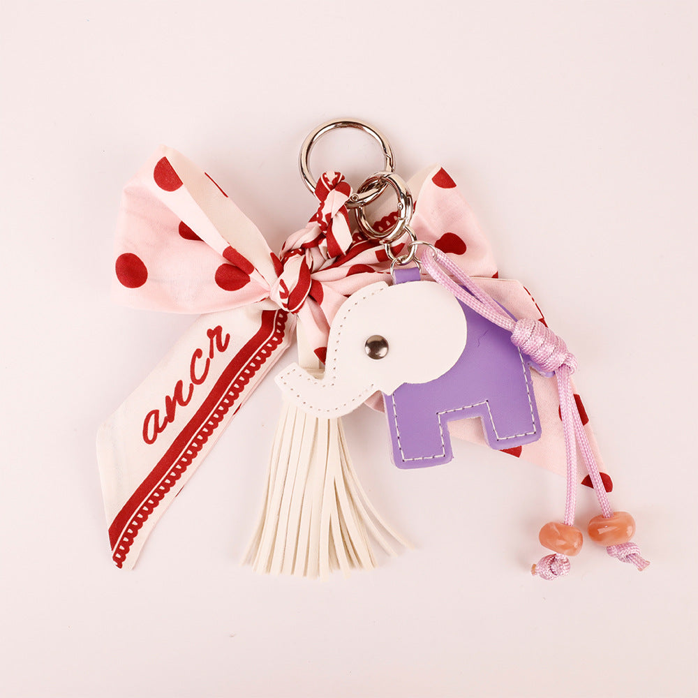Close-up view of the bow and tassel bag charm