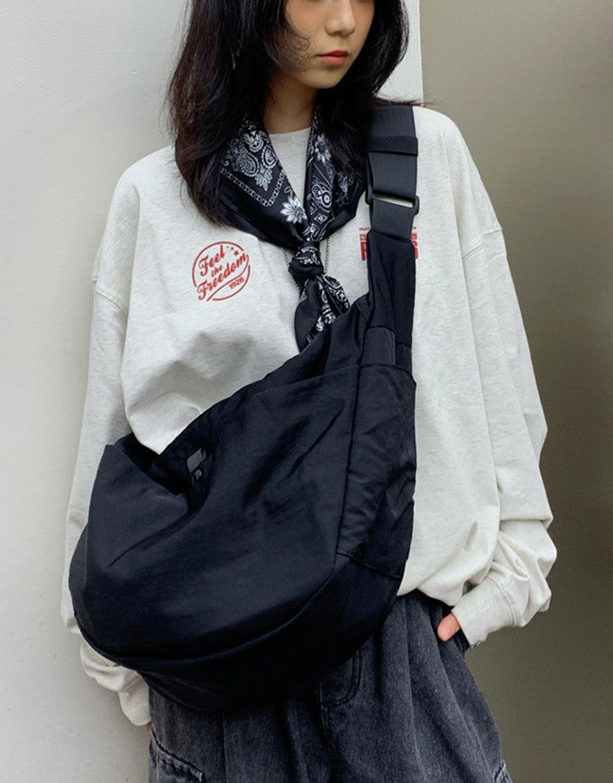 Ergonomic wide strap crossbody bag designed for shoulder weight relief