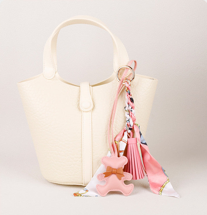 Adorable bear bag charm styled on a luxury leather tote shoulder bag