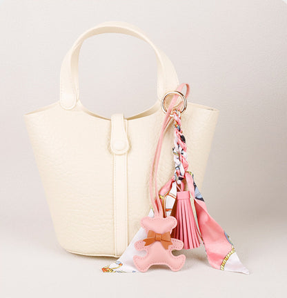 Adorable bear bag charm styled on a luxury leather tote shoulder bag