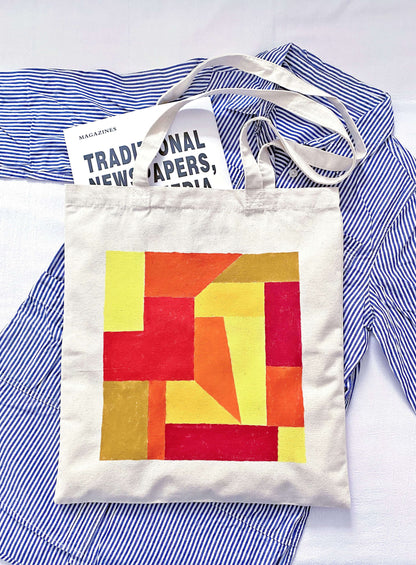 Person carrying a slouchy oversized tote bag during a morning flower market run.