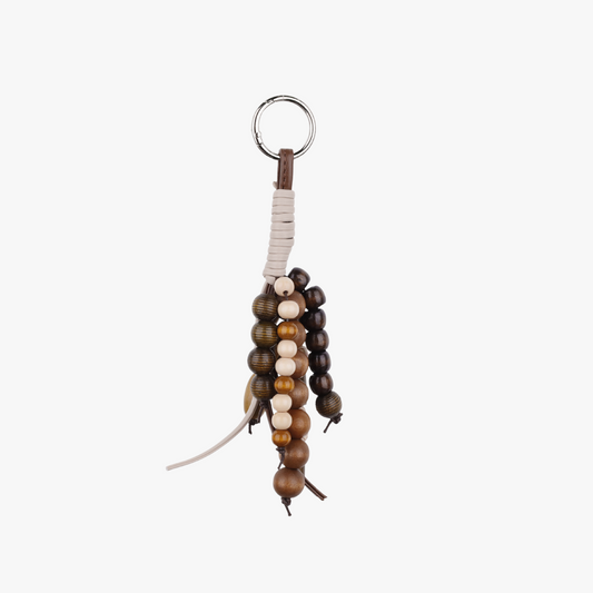 Close-up of a handwoven pendant with natural wood beads