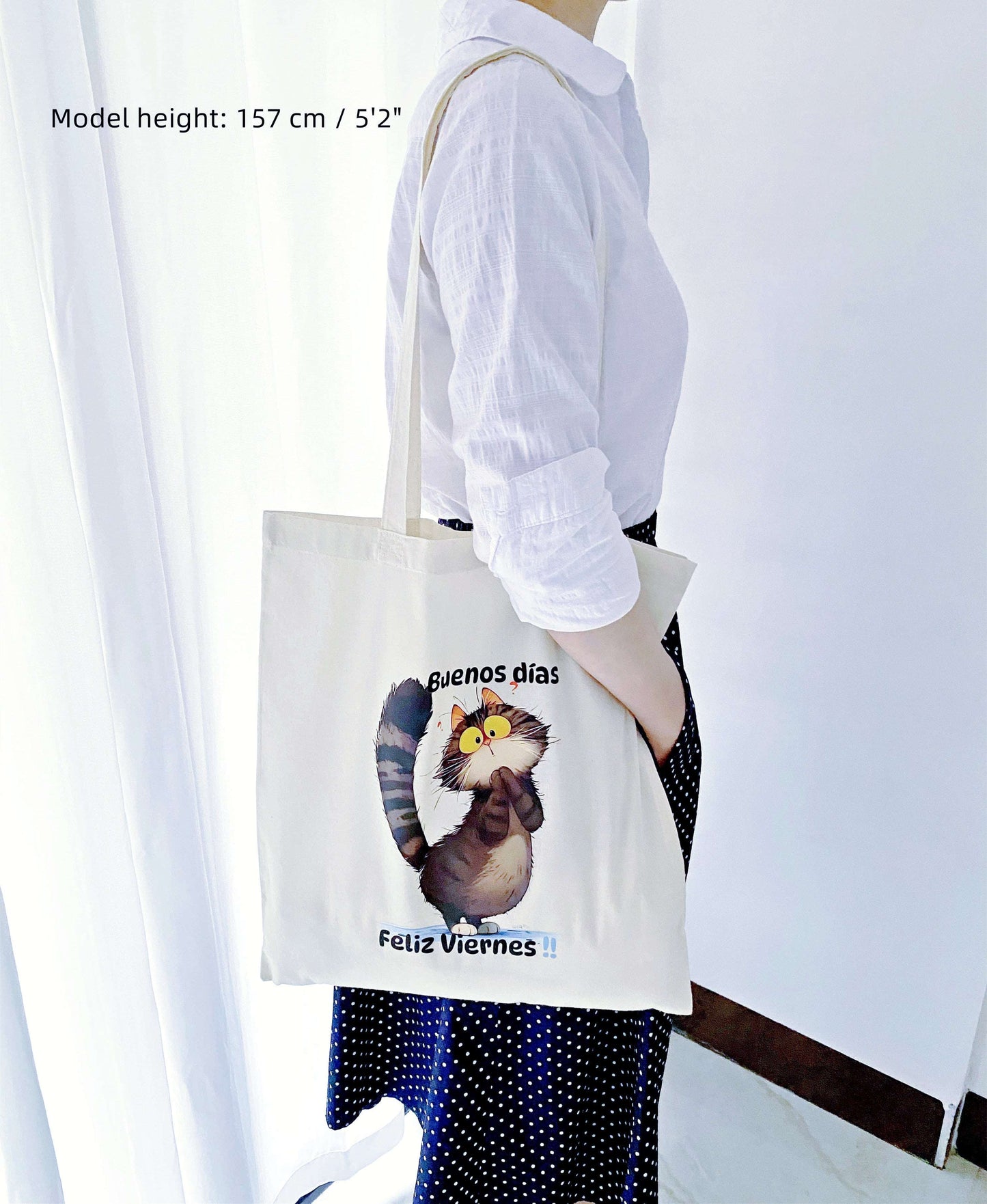 Lightweight cotton market tote holding fresh flowers, featuring a relaxed kitty print for slow-living weekends.