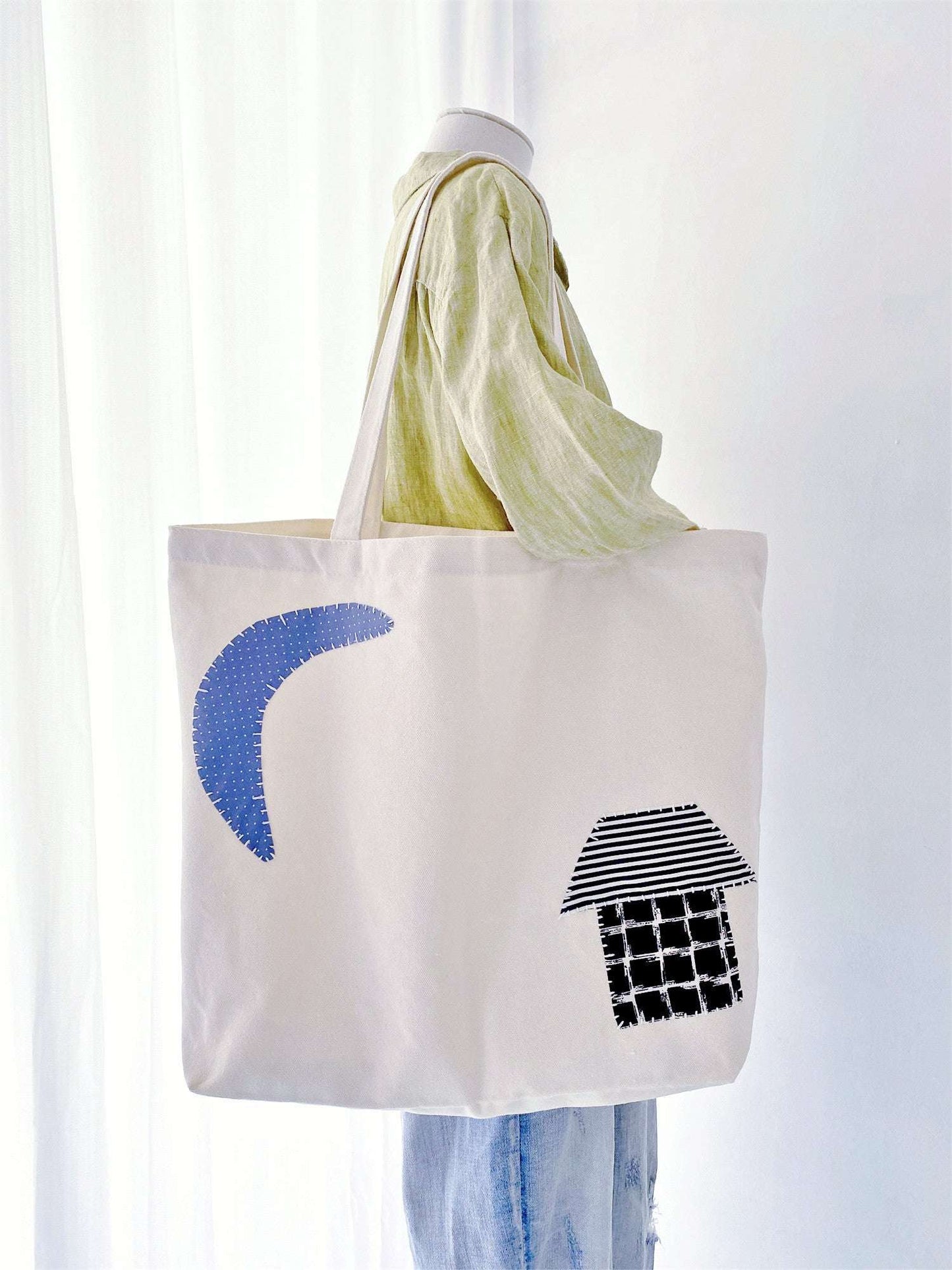 Open fabric bag filled with fresh market greens, an eco-friendly choice for plastic-free grocery shopping.