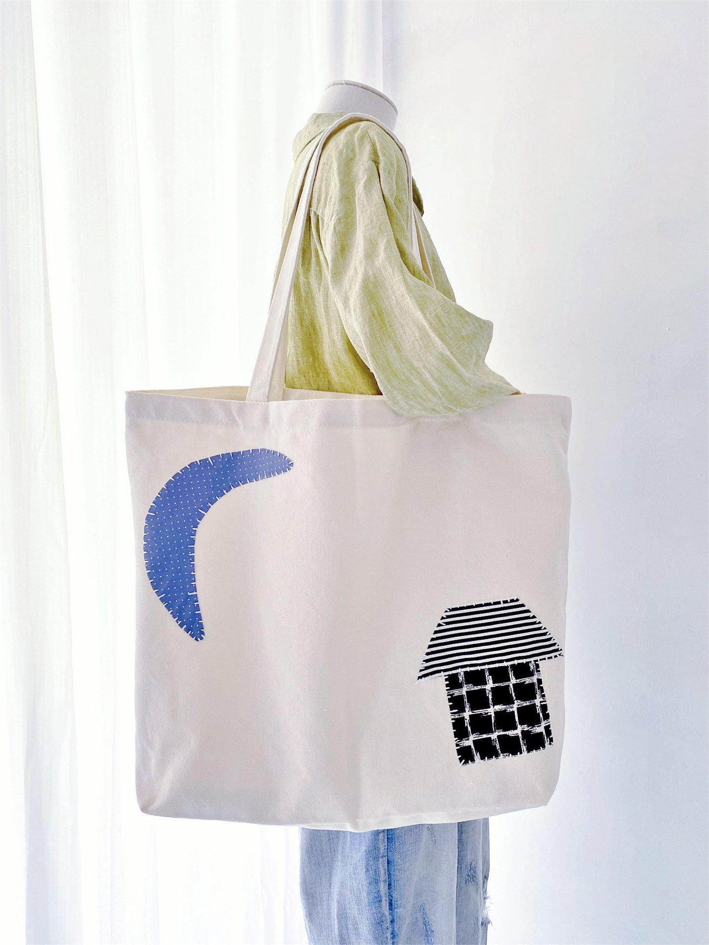 Open fabric bag filled with fresh market greens, an eco-friendly choice for plastic-free grocery shopping.