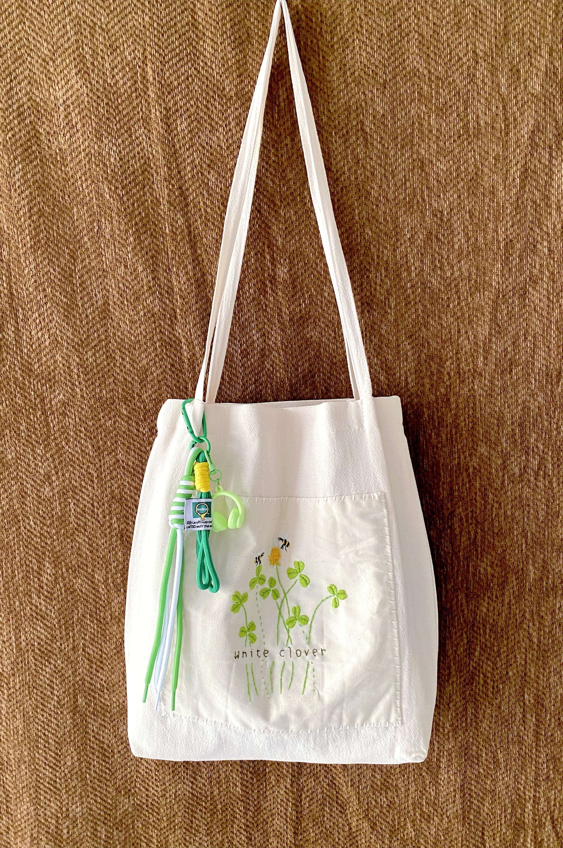 Aesthetic gift idea: a relaxed-fit linen bag with hand-detailed botanical art for a personal touch.