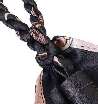 Colorful scarf tassel hanging beside a handbag