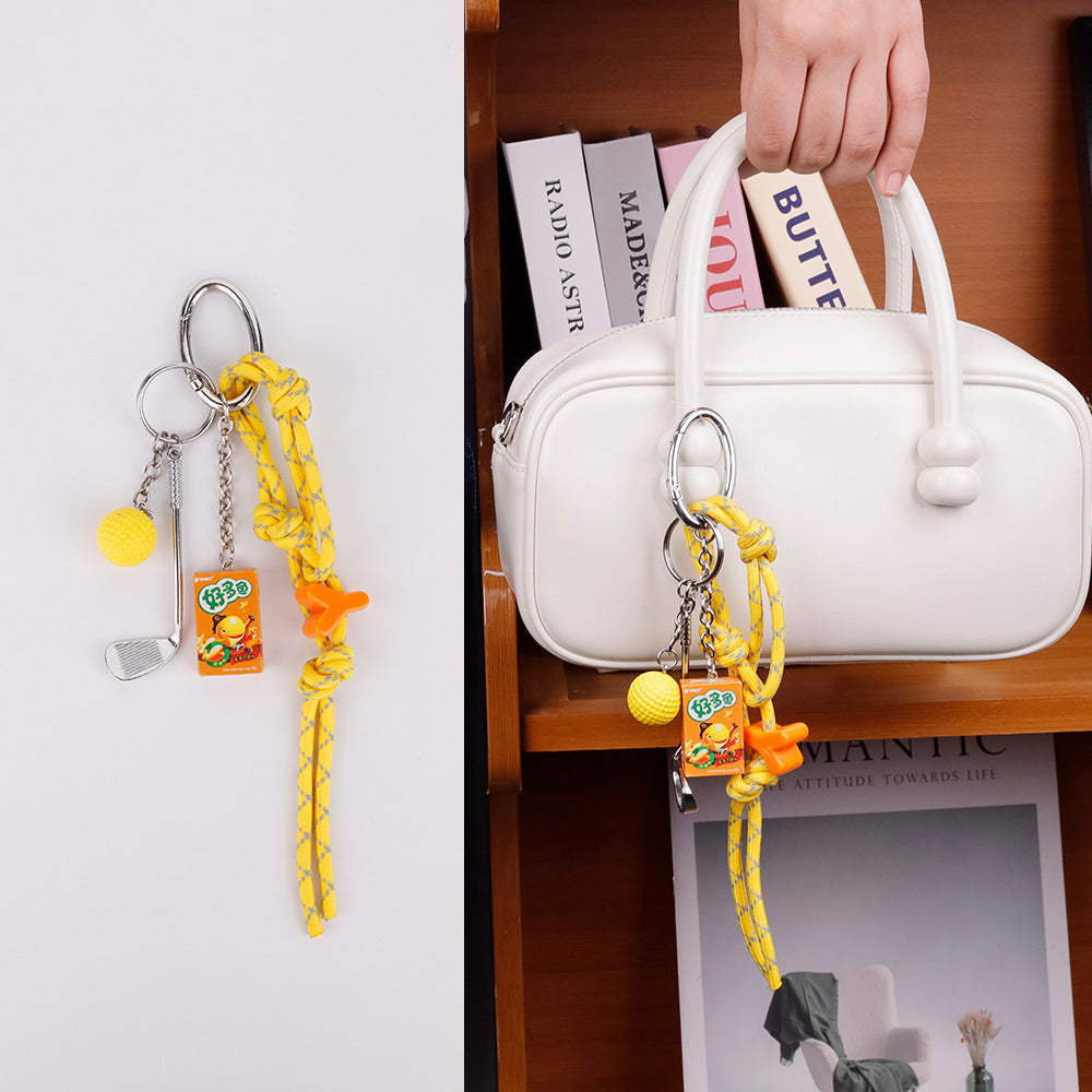 Athletic yellow purse accessory attached to a school backpack zipper pull