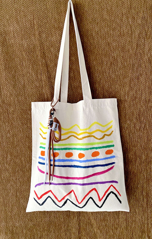 unstructured canvas tote bag placed next to a half-read book