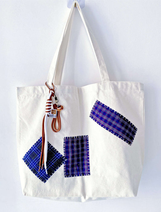 Hand-stitched textile patterns on a bag that tells a story of craftsmanship.