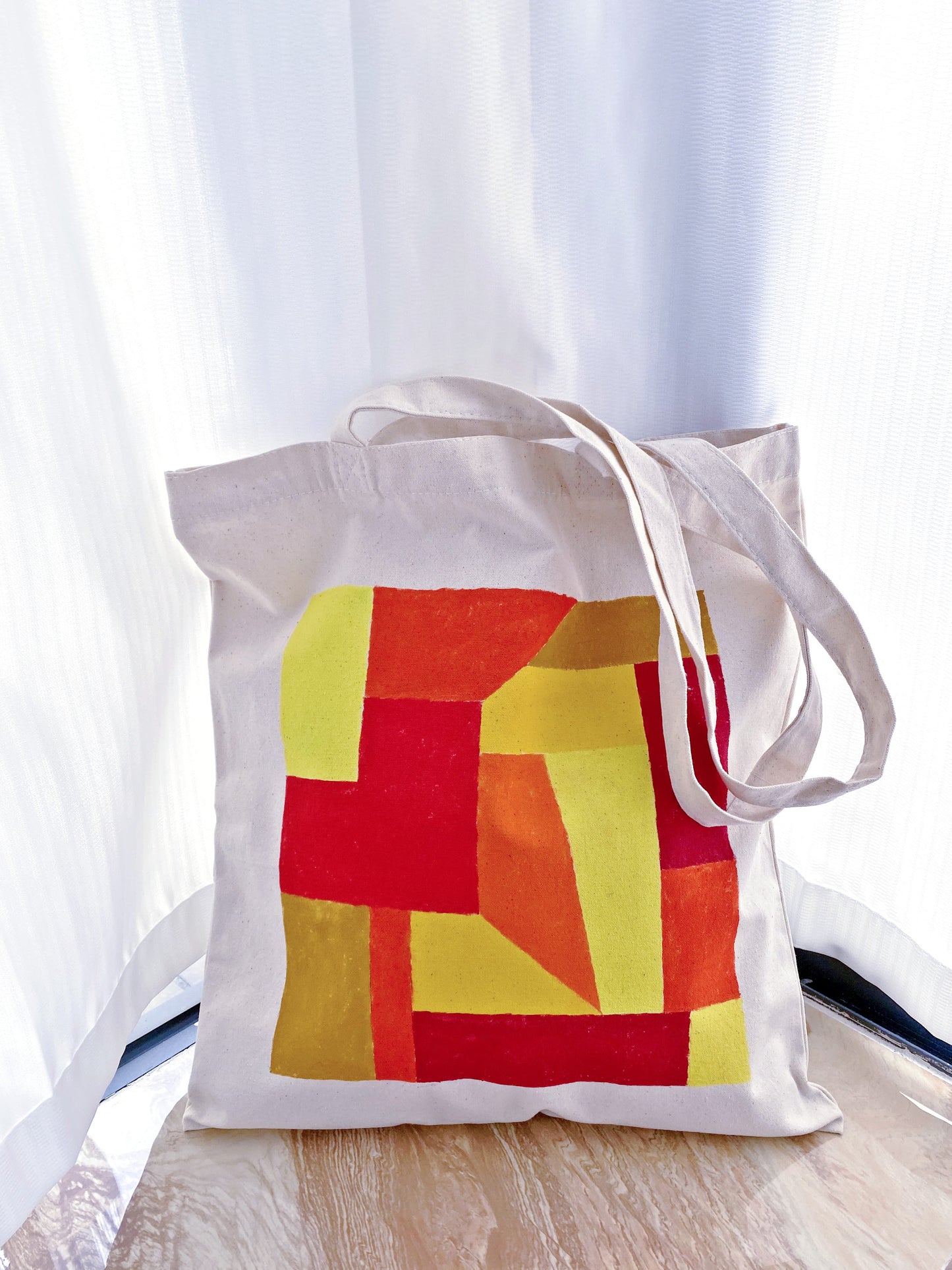 A minimalist lifestyle shot of the bag paired with denim and a white t-shirt.