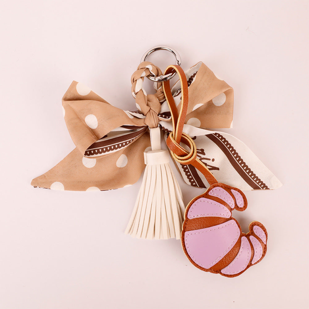 Tassel bag hanger with a handmade scarf bow